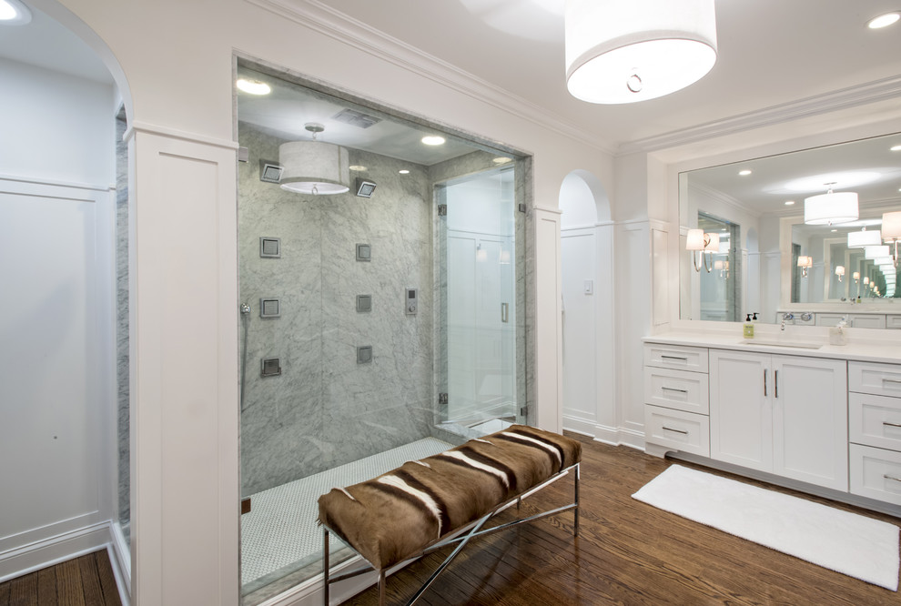 Large transitional master bathroom in Louisville with an undermount sink, recessed-panel cabinets, white cabinets, engineered quartz benchtops, a double shower, stone slab, white walls and medium hardwood floors.