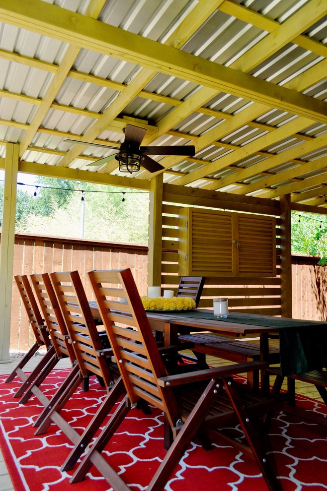 Design ideas for a large modern backyard patio in Austin with an awning.