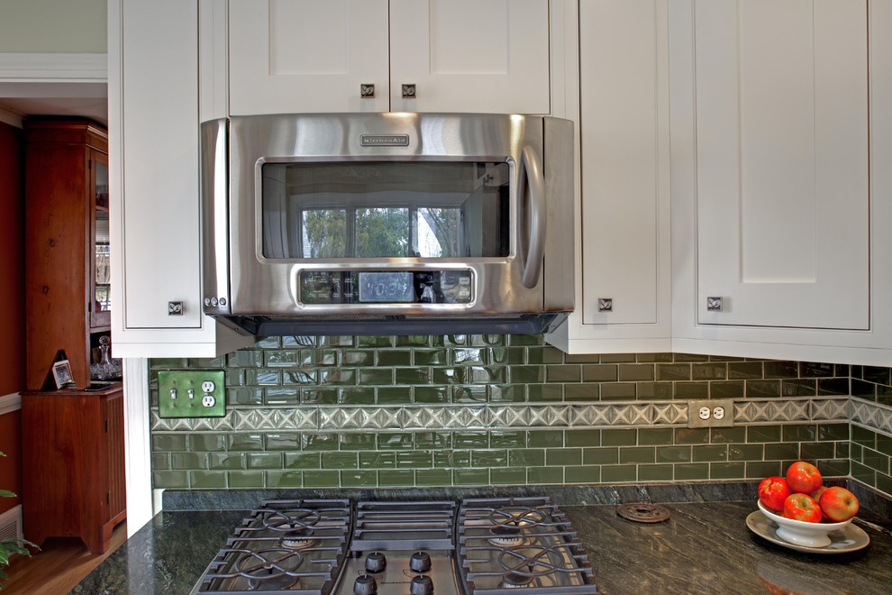 Photo of a traditional kitchen in DC Metro with shaker cabinets, white cabinets and green splashback.