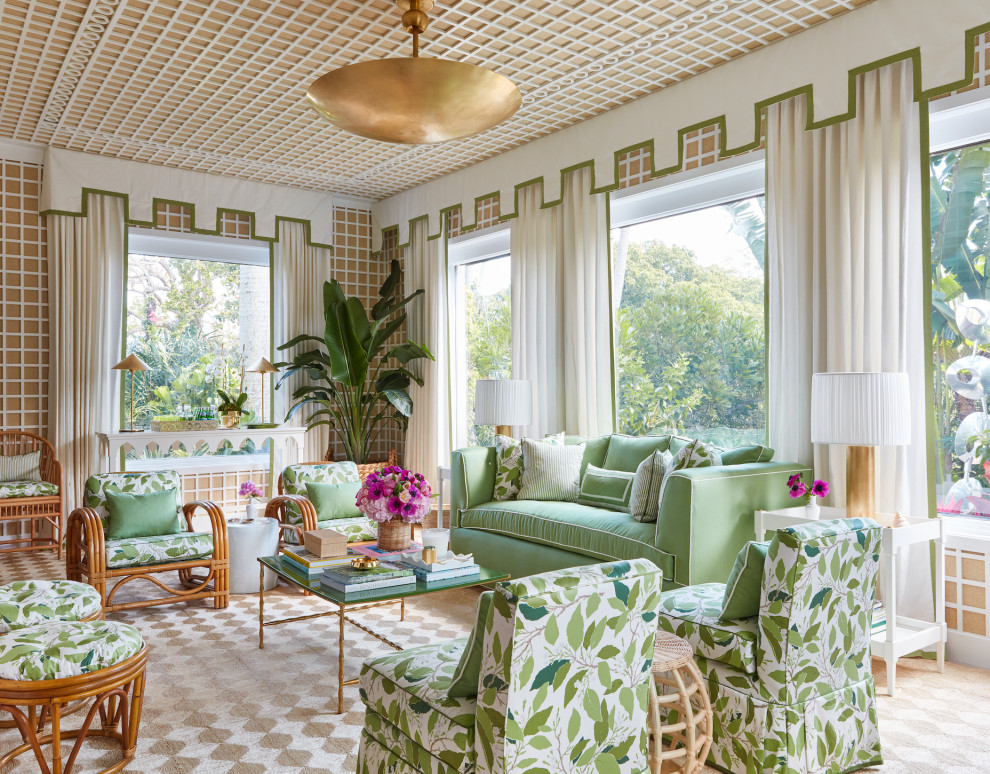 This is an example of a tropical living room in New York with multi-coloured walls, carpet, beige floor and wallpaper.