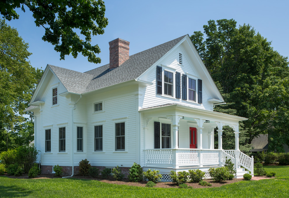 This is an example of a mid-sized traditional two-storey white house exterior in Providence with concrete fiberboard siding, a gable roof and a shingle roof.