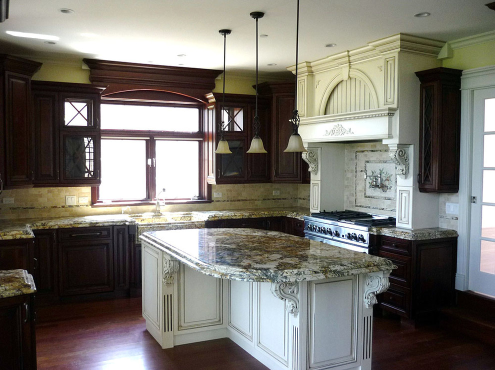 Inspiration for a large dark wood floor eat-in kitchen remodel in Miami with a drop-in sink, raised-panel cabinets, dark wood cabinets, marble countertops, beige backsplash, ceramic backsplash, stainless steel appliances and an island