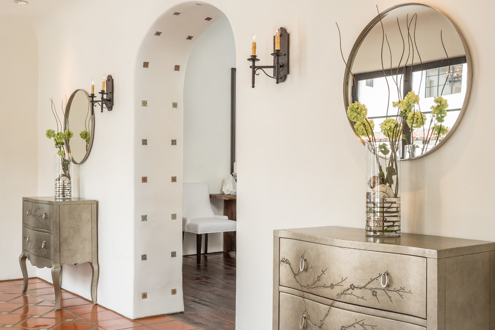 Photo of a mediterranean hallway in Los Angeles with beige walls and terra-cotta floors.