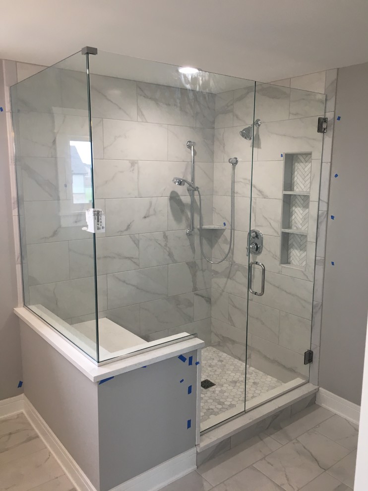 This is an example of a mid-sized contemporary master bathroom in Chicago with a corner shower, gray tile, white tile, marble, grey walls, marble floors, white floor and a hinged shower door.