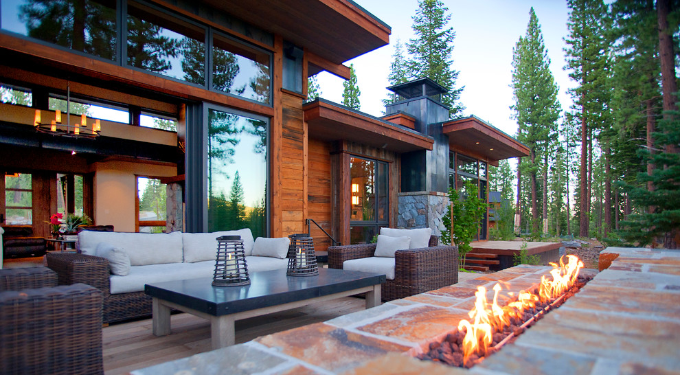 Mountain style backyard deck photo in Sacramento with decking and a roof extension