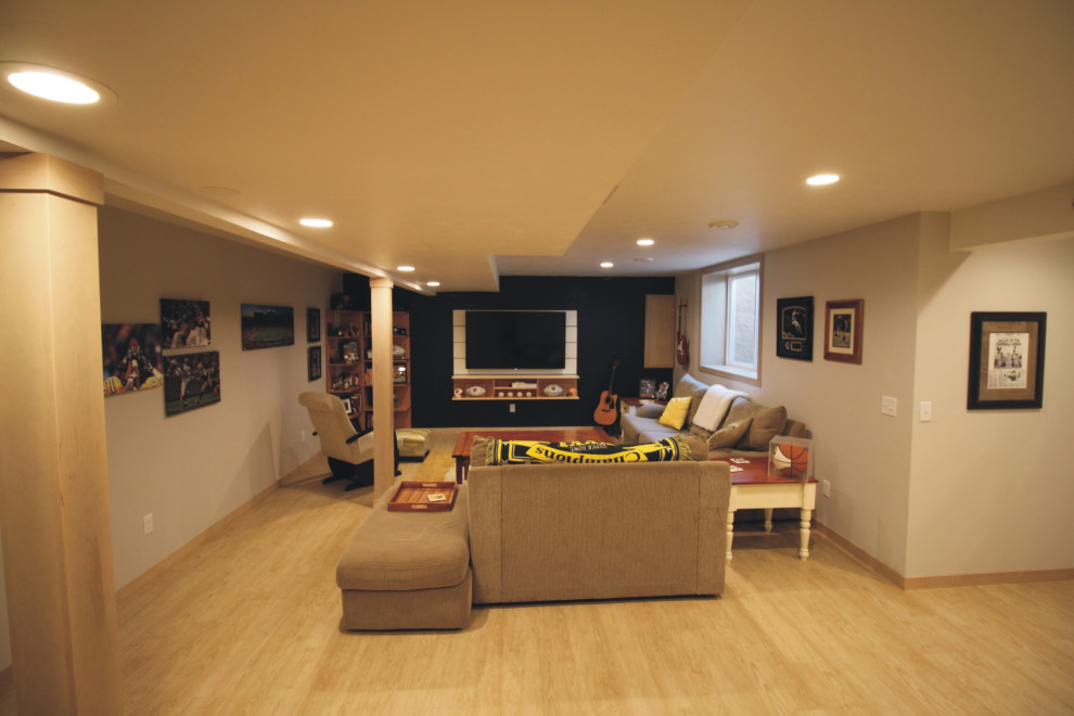 Photo of a mid-sized contemporary fully buried basement in Other with a game room, laminate floors and yellow floor.