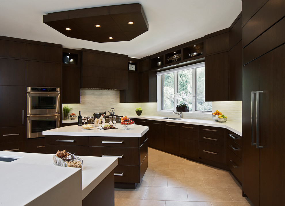 Large transitional u-shaped porcelain tile enclosed kitchen photo in Toronto with an undermount sink, flat-panel cabinets, dark wood cabinets, quartz countertops, beige backsplash, stone tile backsplash, stainless steel appliances and an island