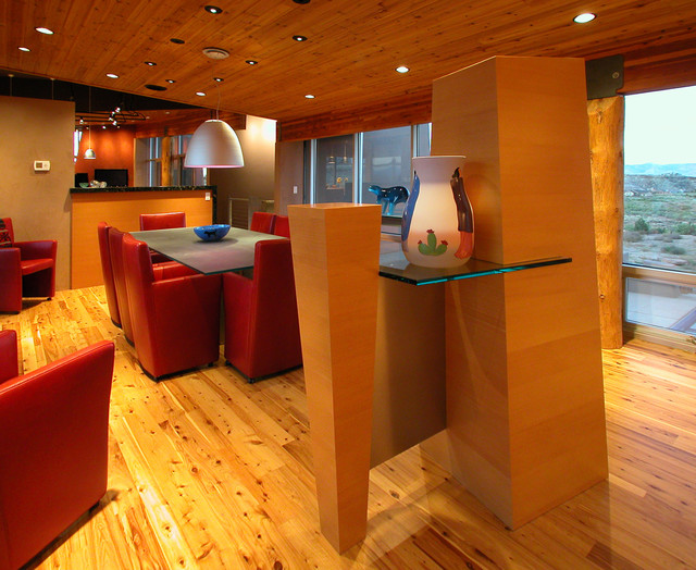 Trendy medium tone wood floor foyer photo in Other with orange walls