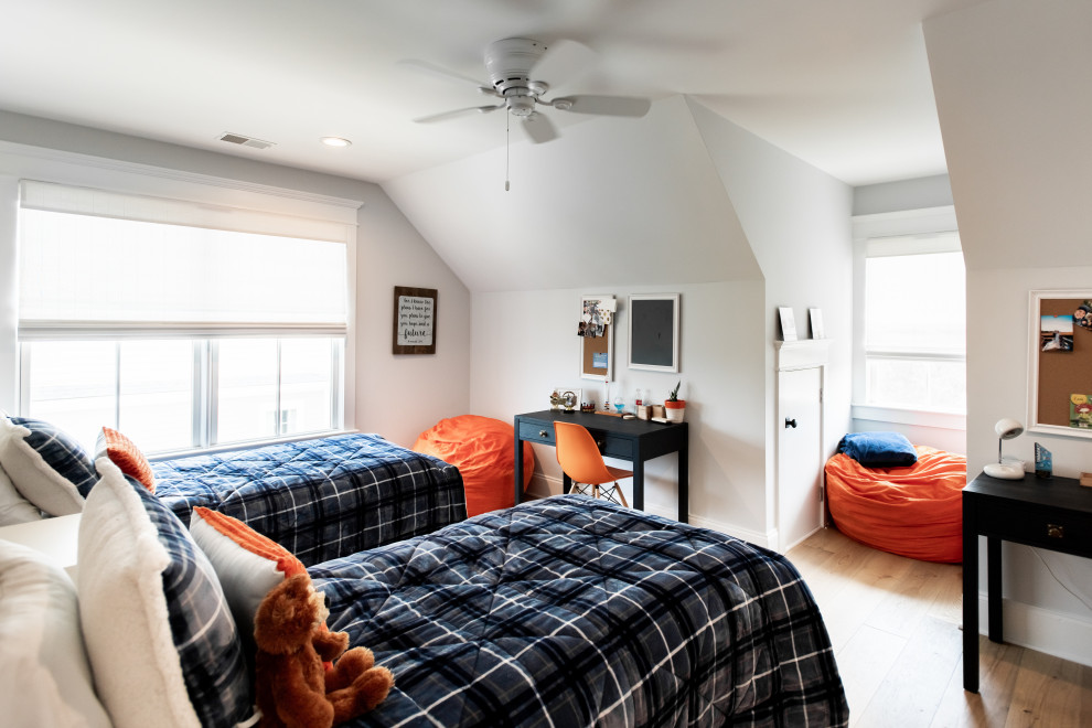 Example of a mid-sized transitional medium tone wood floor bedroom design in Charleston with gray walls