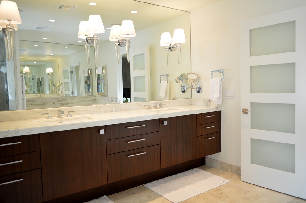 This is an example of a large contemporary master bathroom in Phoenix with flat-panel cabinets, dark wood cabinets, an alcove shower, multi-coloured tile, stone tile, white walls, limestone floors, an undermount sink and engineered quartz benchtops.