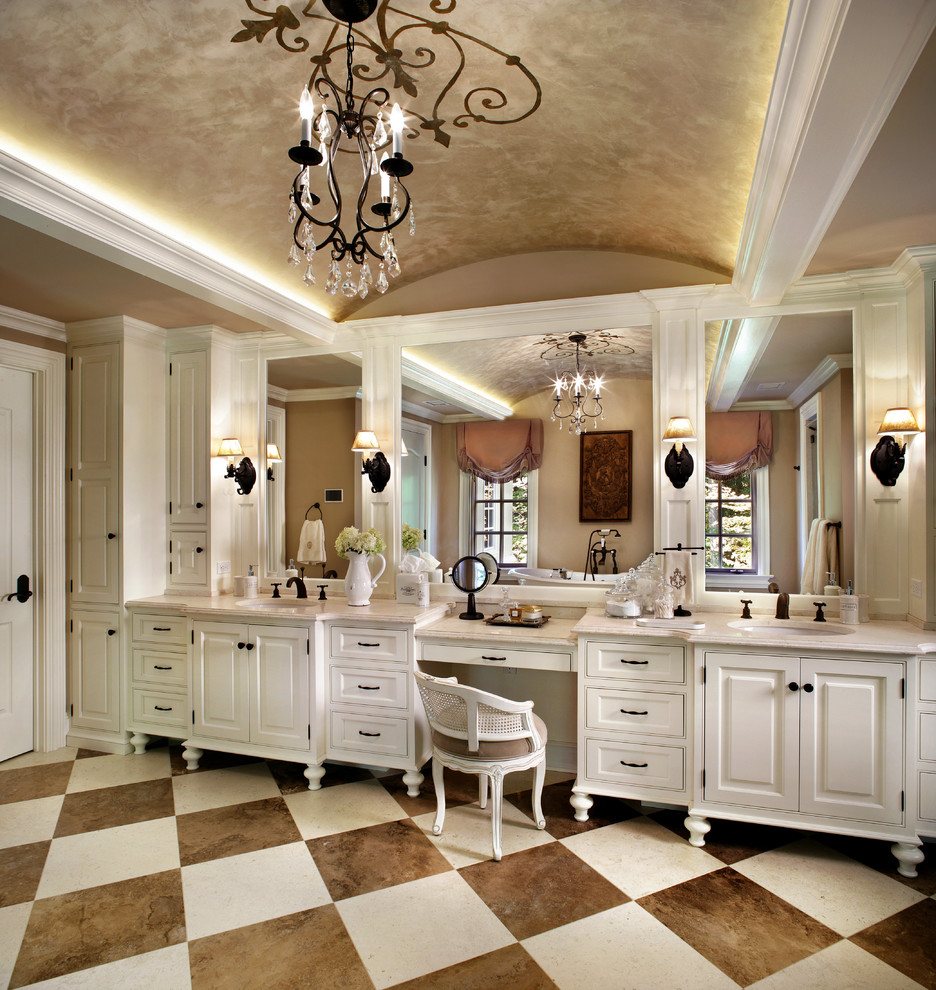 Inspiration for a large traditional bathroom in New York with an undermount sink, white cabinets, an alcove shower, beige walls, limestone benchtops, limestone floors and raised-panel cabinets.