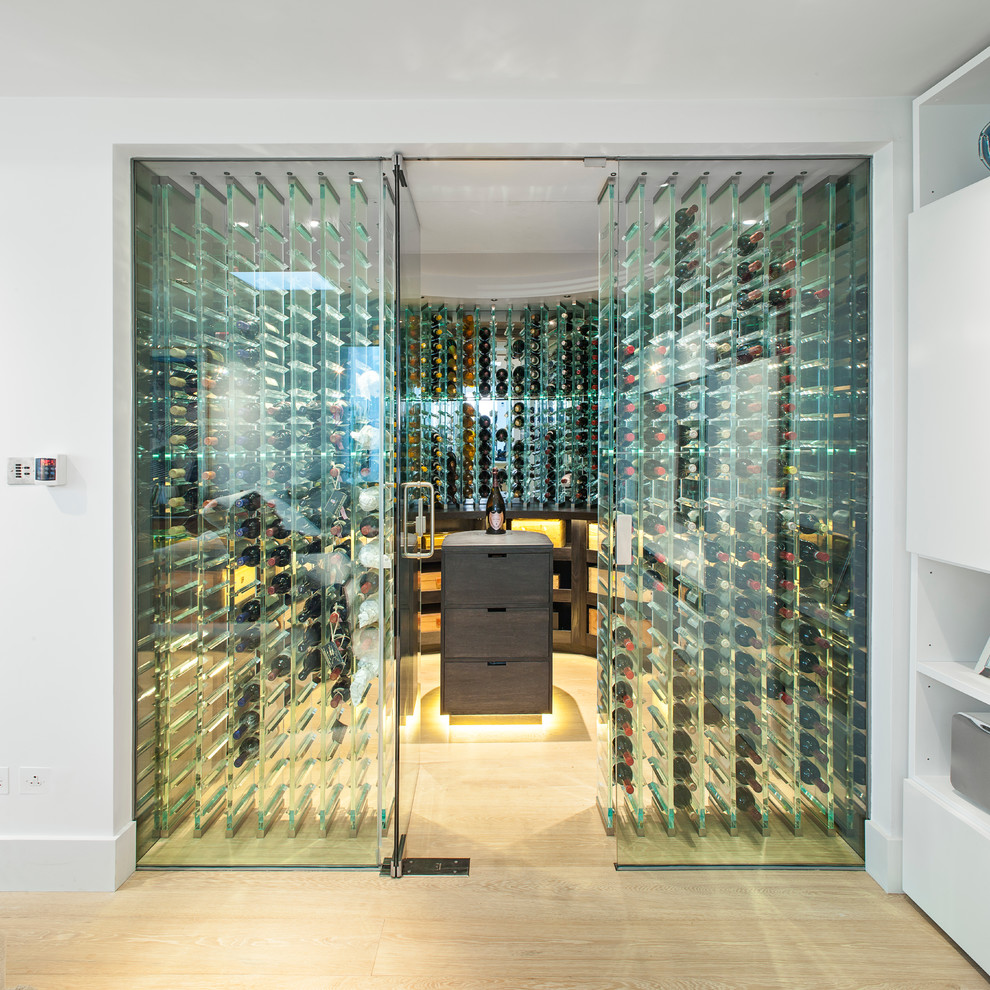 Inspiration for a contemporary wine cellar in London with light hardwood floors and storage racks.
