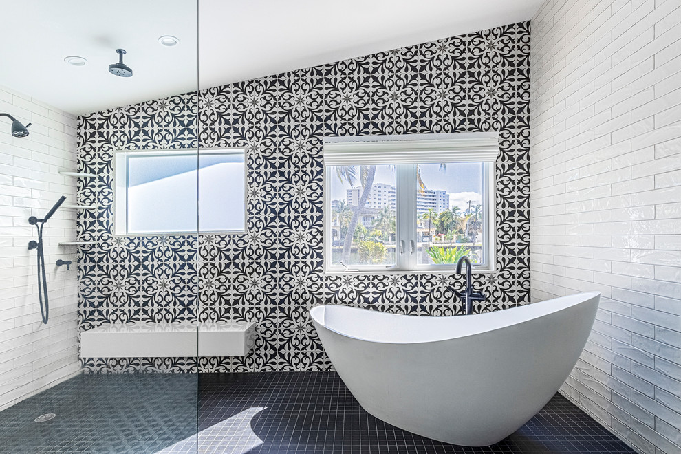 Inspiration for an expansive eclectic bathroom in Miami with flat-panel cabinets, black cabinets, a freestanding tub, a curbless shower, a one-piece toilet, black and white tile, cement tile, white walls, porcelain floors, an undermount sink, engineered quartz benchtops, black floor, an open shower and white benchtops.