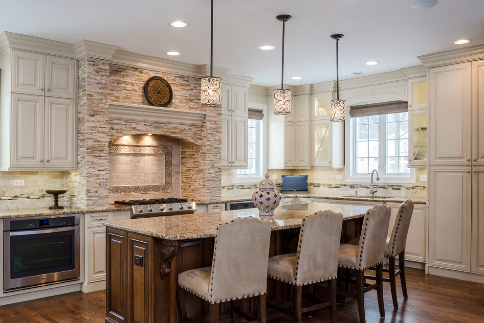 Inspiration for a large transitional u-shaped medium tone wood floor eat-in kitchen remodel in Chicago with an undermount sink, raised-panel cabinets, white cabinets, granite countertops, multicolored backsplash, subway tile backsplash, stainless steel appliances and beige walls