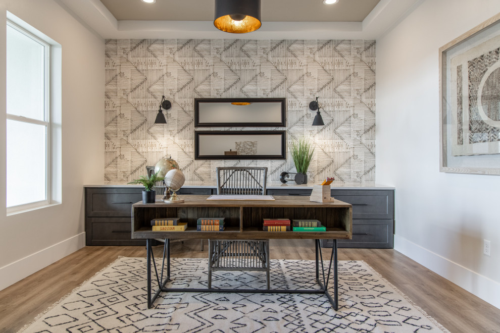 Transitional freestanding desk wallpaper, medium tone wood floor, brown floor and tray ceiling home office photo with gray walls