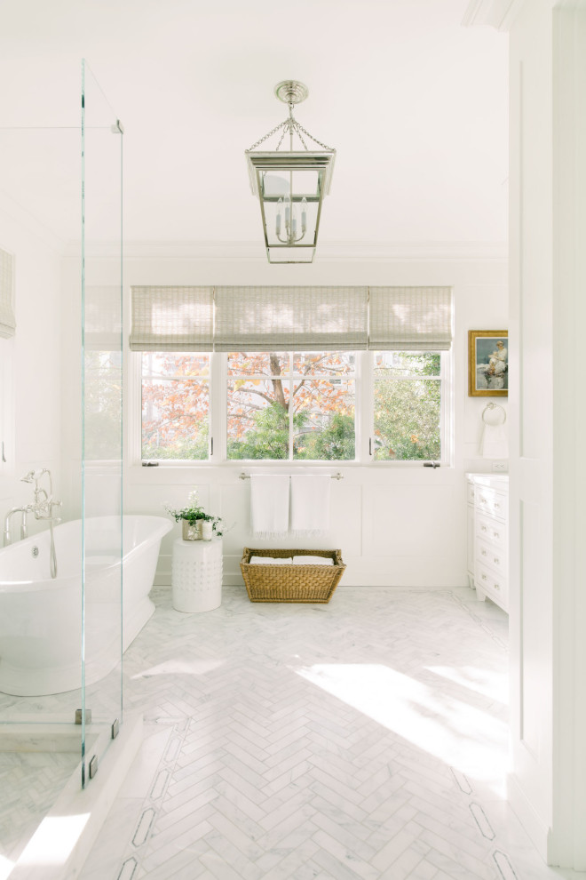 Beach style bathroom in Los Angeles with a freestanding tub, white walls, white cabinets, a corner shower, white floor, a hinged shower door, white benchtops and a freestanding vanity.