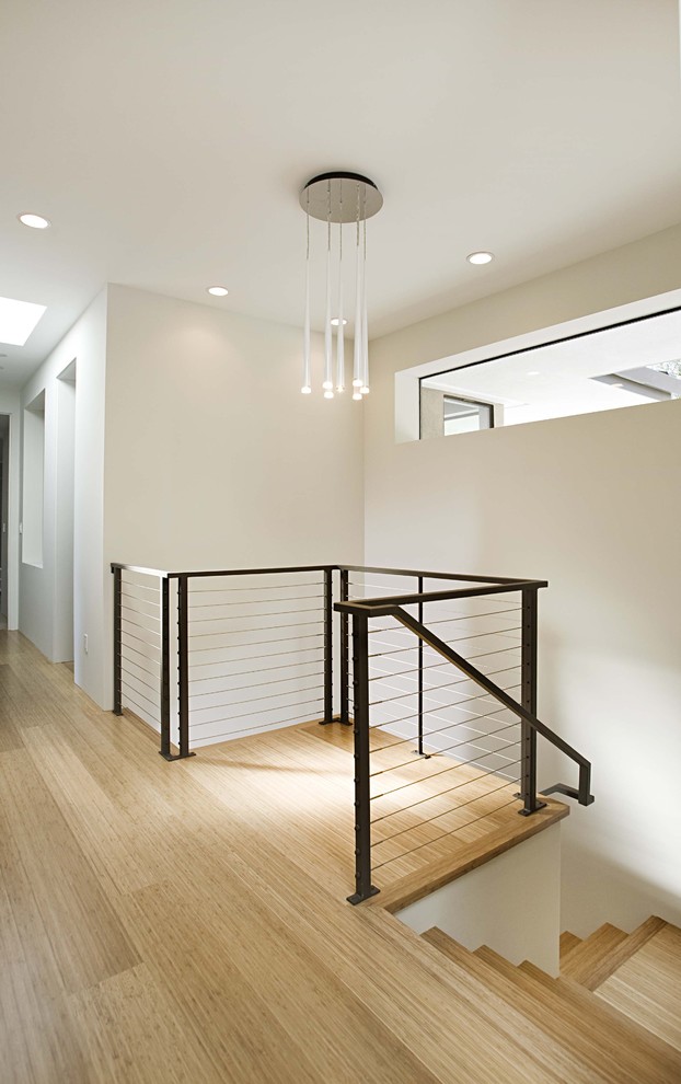Inspiration for a contemporary wood staircase in San Francisco with cable railing.