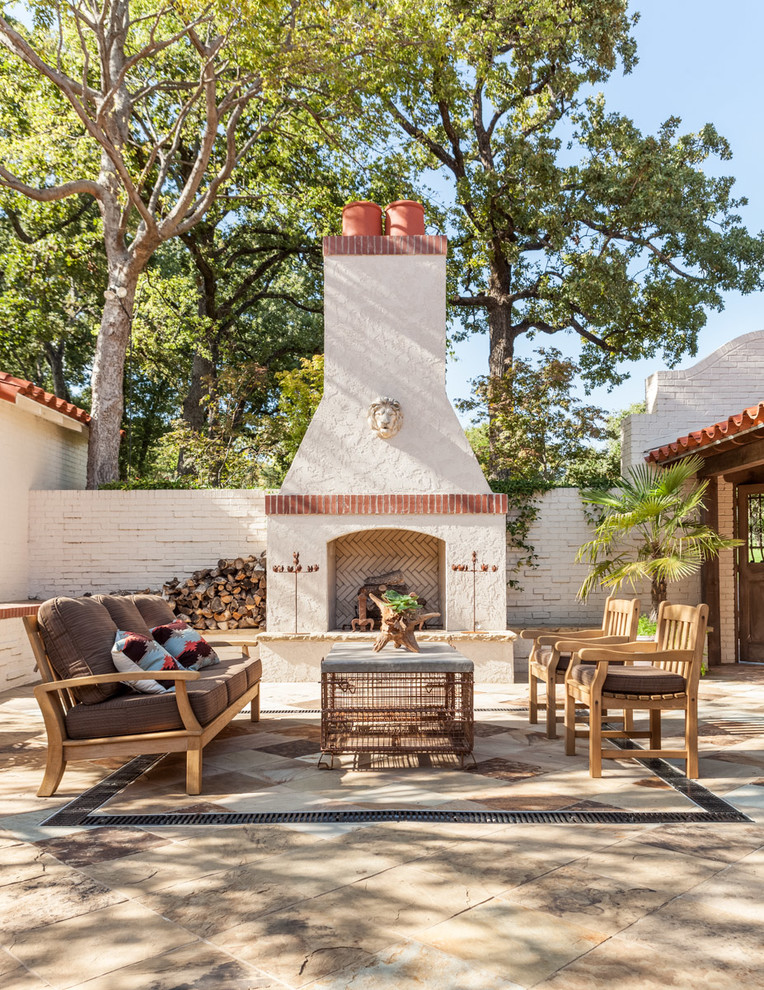 Photo of a mediterranean patio in Dallas with tile and with fireplace.