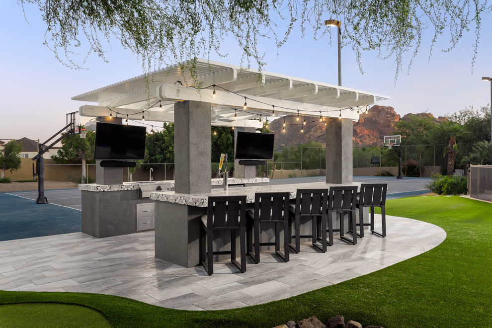 Design ideas for a large modern backyard garden in Phoenix with natural stone pavers.