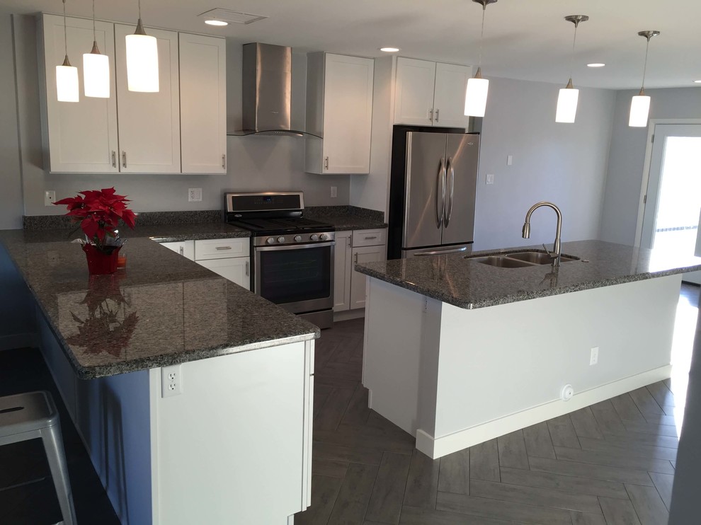 Mid-sized transitional u-shaped dark wood floor eat-in kitchen photo with a double-bowl sink, raised-panel cabinets, dark wood cabinets, wood countertops, white backsplash, subway tile backsplash, white appliances and no island