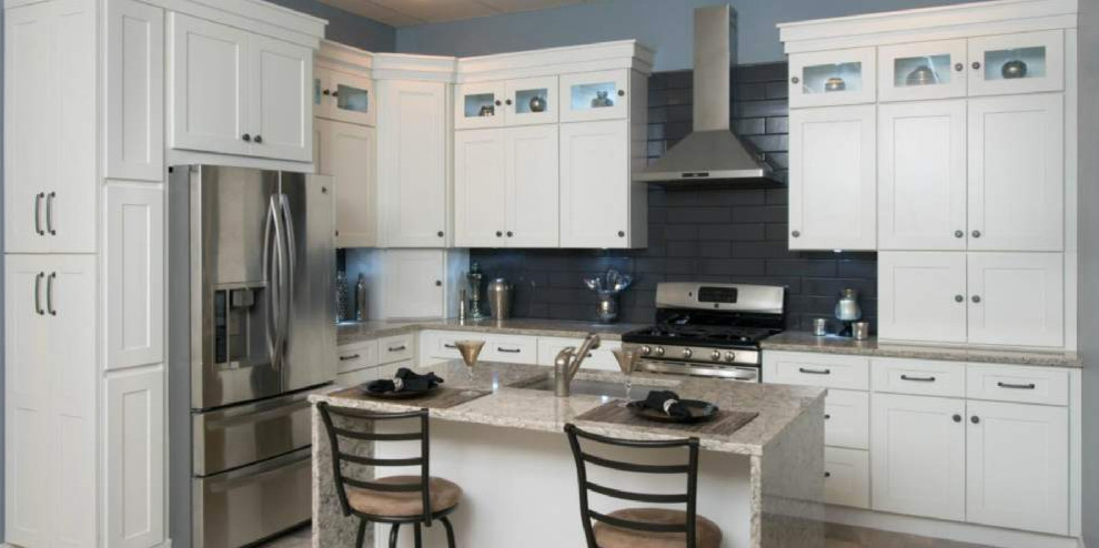 Inspiration for a mid-sized transitional l-shaped open concept kitchen remodel with an undermount sink, shaker cabinets, white cabinets, granite countertops, blue backsplash, ceramic backsplash, stainless steel appliances, an island and gray countertops