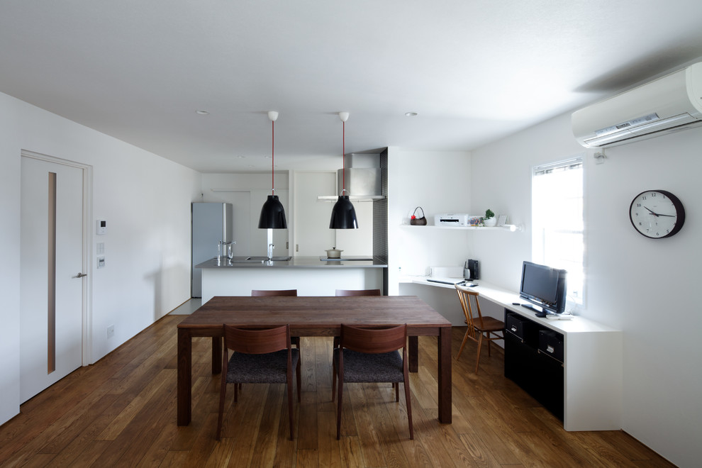 Photo of a mid-sized modern open plan dining in Other with white walls, medium hardwood floors and brown floor.