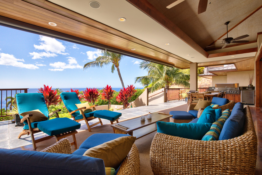 This is an example of a tropical patio in Hawaii with a roof extension.