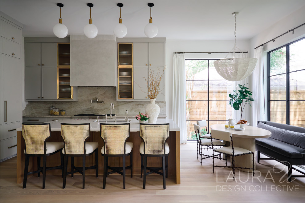 Mid-sized transitional l-shaped light wood floor and brown floor open concept kitchen photo in Houston with an undermount sink, glass-front cabinets, blue cabinets, multicolored backsplash, stainless steel appliances, an island and multicolored countertops
