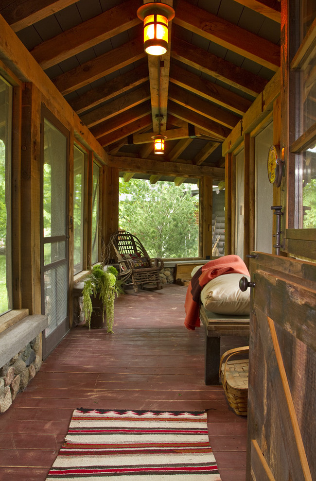 This is an example of a country verandah in Minneapolis with decking and a roof extension.