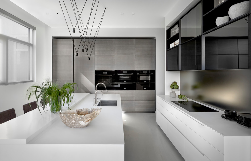 Inspiration for a contemporary kitchen in Chicago with an undermount sink, glass-front cabinets, white cabinets, metallic splashback, mirror splashback, porcelain floors, with island, grey floor and white benchtop.