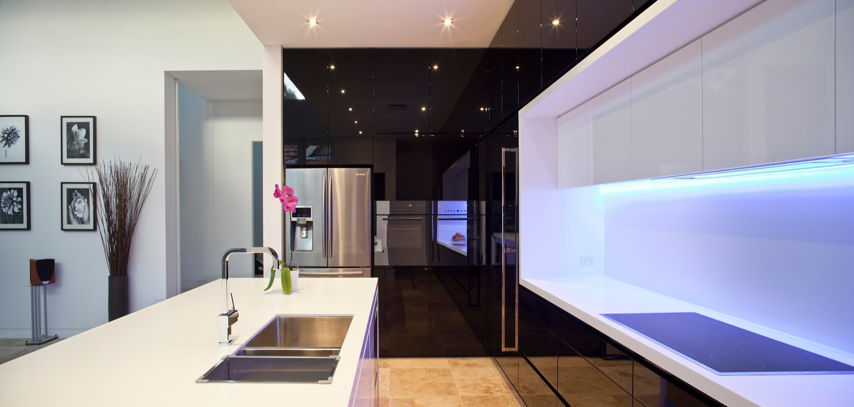 black gloss kitchen with white stone