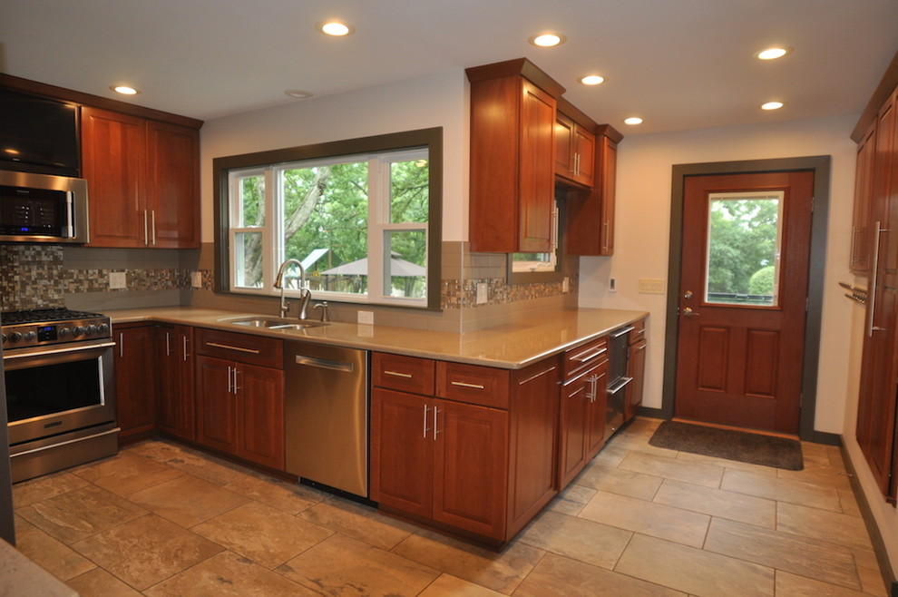 Kitchen - kitchen idea in Chicago with stainless steel appliances and beige countertops