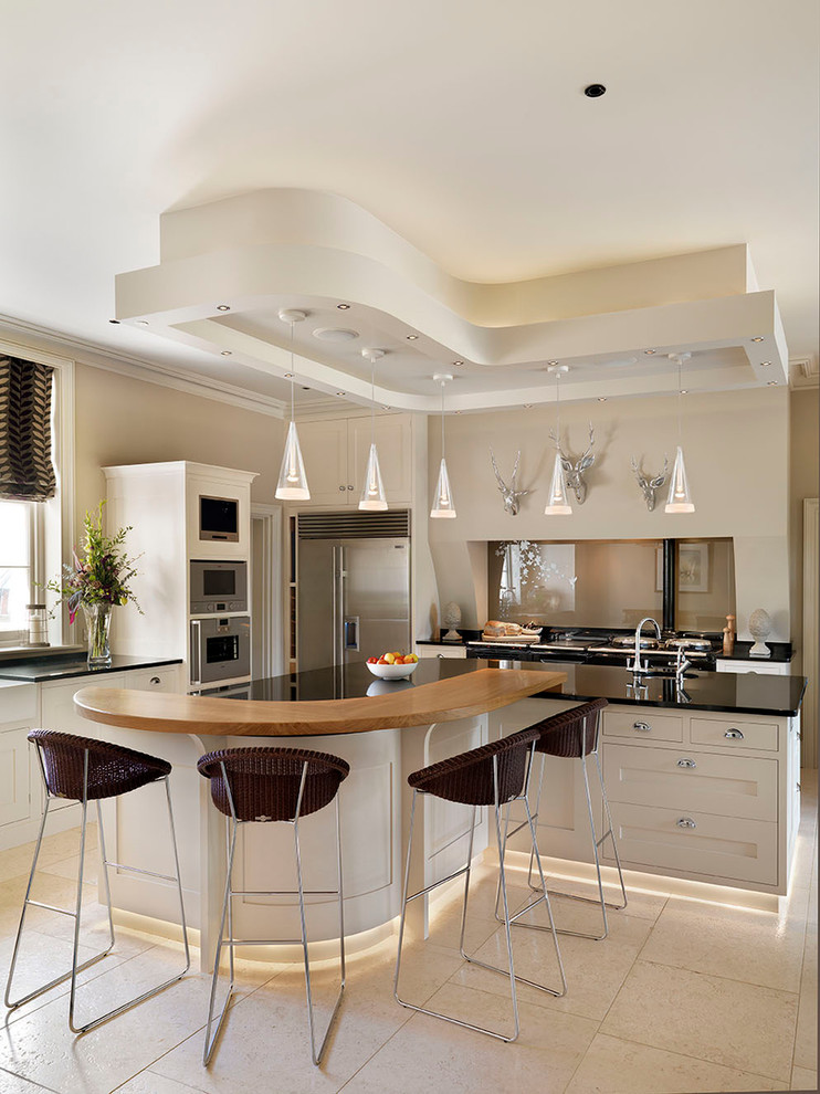 Design ideas for a large contemporary u-shaped eat-in kitchen in Calgary with a single-bowl sink, glass-front cabinets, white cabinets, solid surface benchtops, black splashback, stone slab splashback, stainless steel appliances, light hardwood floors and with island.