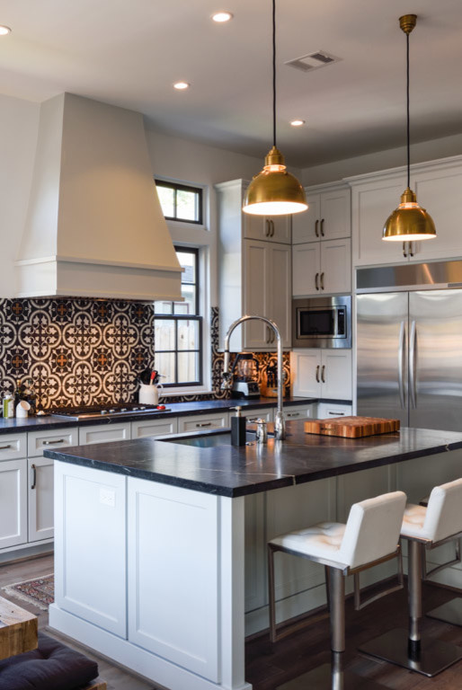 Kitchen - large transitional light wood floor kitchen idea in Houston with an undermount sink, recessed-panel cabinets, white cabinets, soapstone countertops, multicolored backsplash, cement tile backsplash, stainless steel appliances and an island
