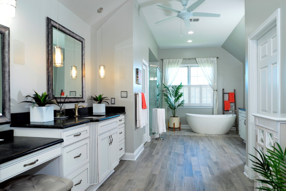 Design ideas for a bathroom in DC Metro with white cabinets, a freestanding tub, white tile and soapstone benchtops.