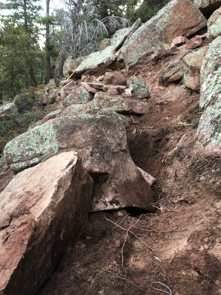 Photo of a huge rustic hillside retaining wall landscape in Denver.