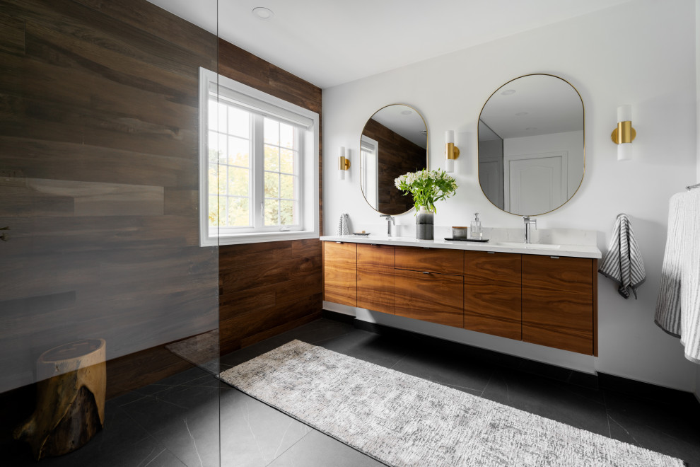 Design ideas for a mid-sized contemporary master bathroom in Montreal with flat-panel cabinets, dark wood cabinets, a curbless shower, a one-piece toilet, brown tile, wood-look tile, white walls, ceramic floors, an undermount sink, engineered quartz benchtops, grey floor, an open shower, white benchtops, a double vanity and a floating vanity.
