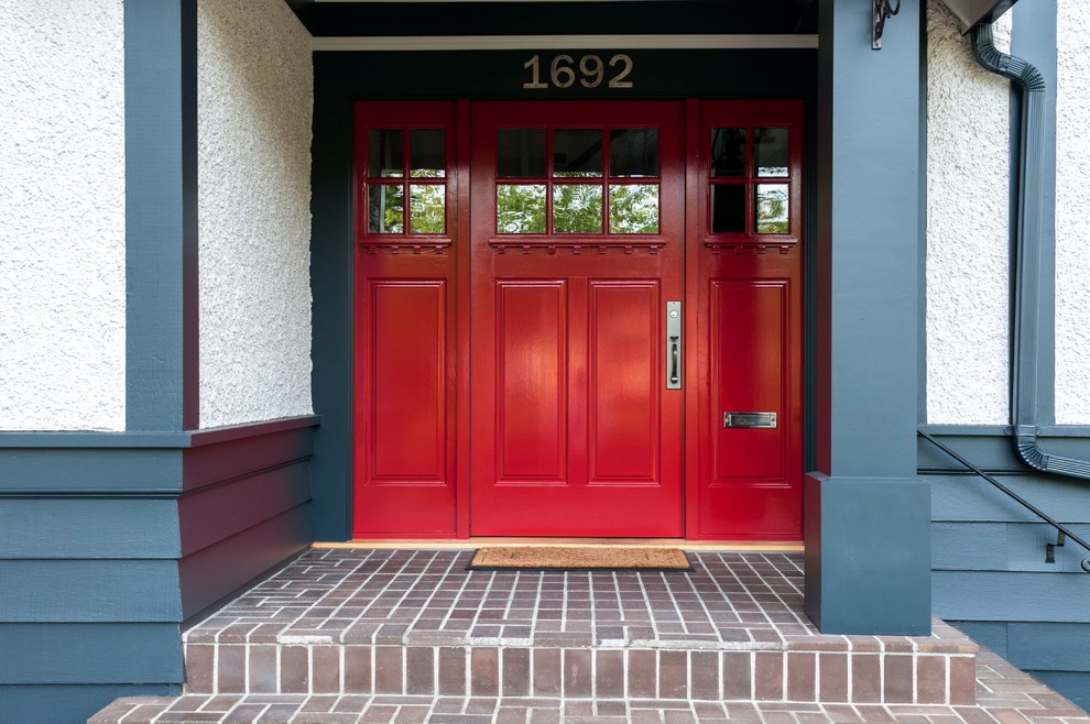 Inspiration for a front door in Vancouver with white walls, a single front door and a red front door.