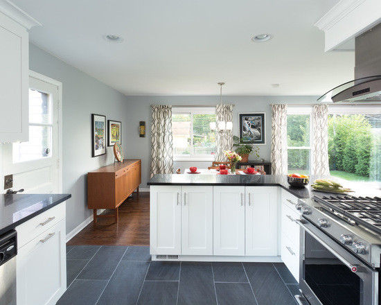 Example of a large transitional l-shaped medium tone wood floor open concept kitchen design in Chicago with an undermount sink, shaker cabinets, white cabinets, granite countertops, multicolored backsplash, ceramic backsplash, stainless steel appliances and no island