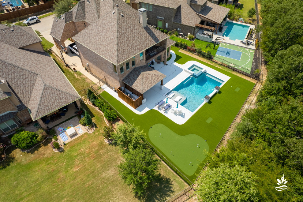 Design ideas for a large modern backyard rectangular natural pool in Dallas with with a pool and decking.