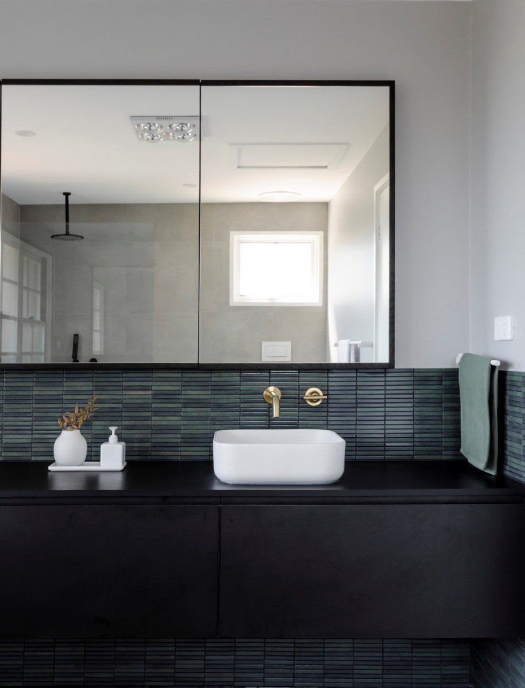 Design ideas for a large contemporary bathroom in Melbourne with beaded inset cabinets, black cabinets, a freestanding tub, an open shower, a bidet, green tile, mosaic tile, grey walls, porcelain floors, a trough sink, laminate benchtops, grey floor, an open shower, black benchtops, a single vanity and a floating vanity.