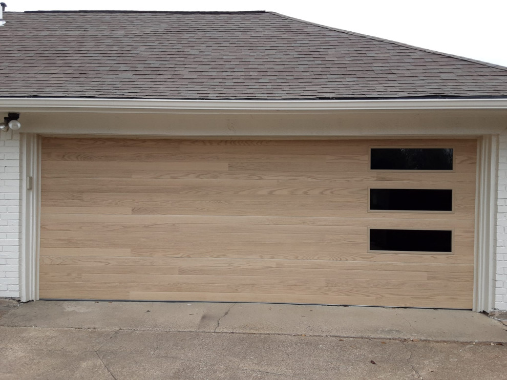 Photo of a large classic attached double garage in Dallas.