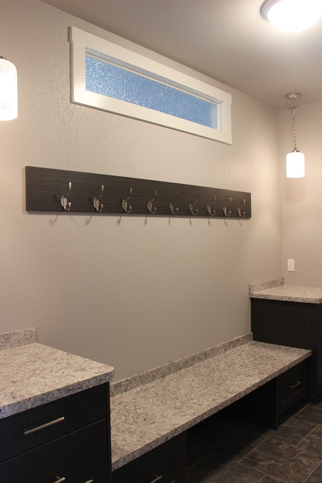Transitional ceramic tile and brown floor home design photo with flat-panel cabinets, dark wood cabinets, granite countertops and beige walls