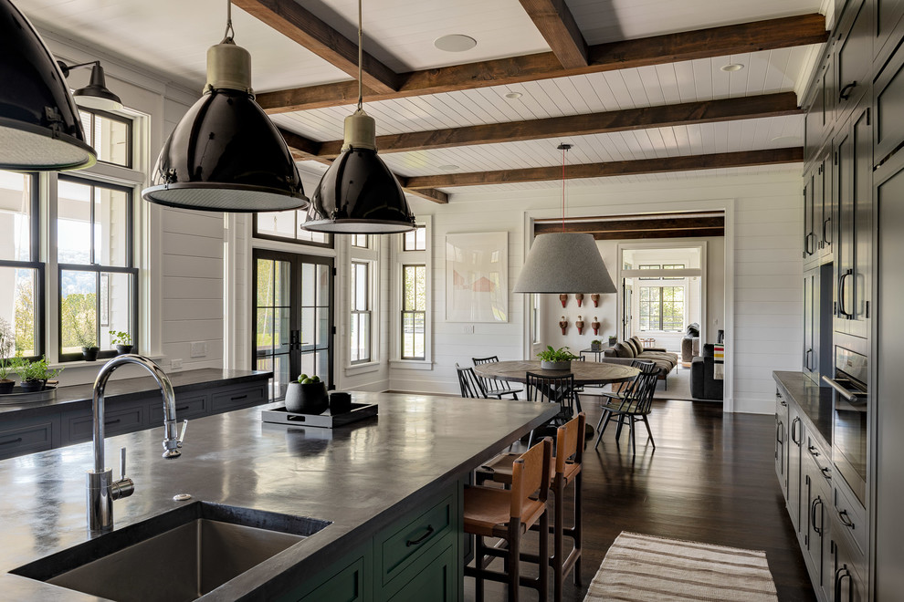 Design ideas for a large country u-shaped eat-in kitchen in New York with a single-bowl sink, shaker cabinets, grey cabinets, concrete benchtops, white splashback, stainless steel appliances, dark hardwood floors, with island, brown floor, black benchtop and shiplap splashback.