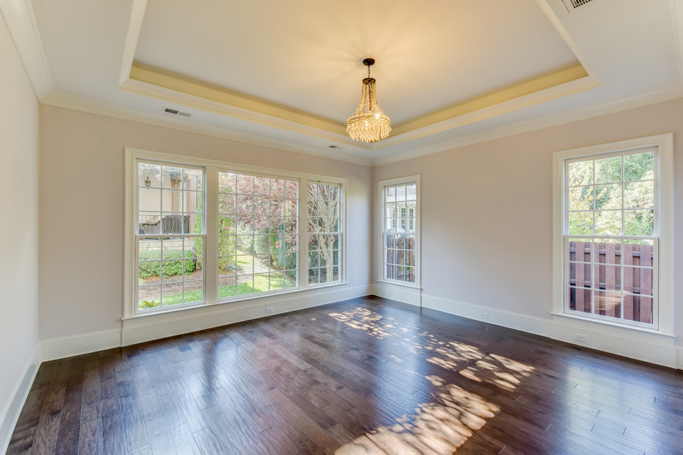 Large transitional master medium tone wood floor home design photo in Charlotte with white walls