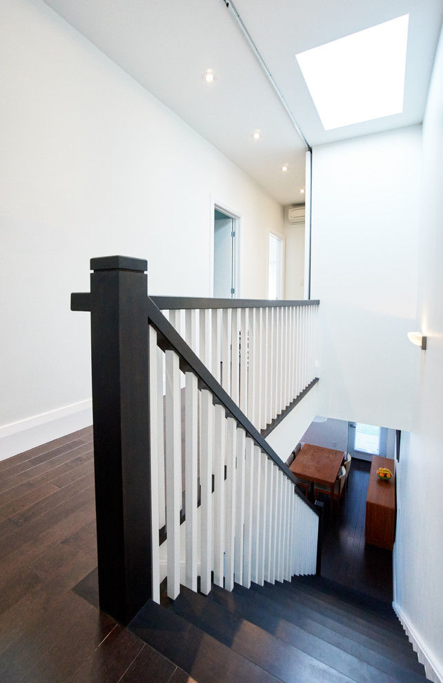 Inspiration for a mid-sized contemporary hallway in Toronto with white walls and dark hardwood floors.