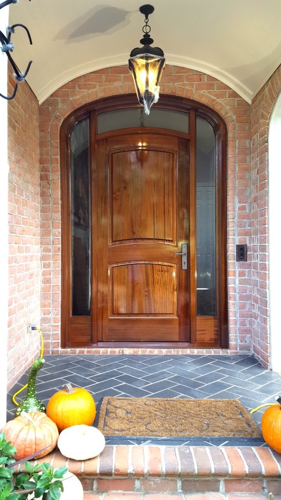 Traditional front door in Other with a single front door and a medium wood front door.