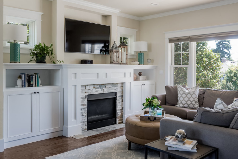 Photo of a medium sized classic formal open plan living room in Seattle with medium hardwood flooring, a standard fireplace, a metal fireplace surround and a wall mounted tv.