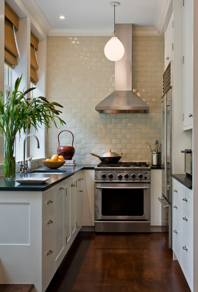 Inspiration for a small transitional u-shaped separate kitchen in New York with white cabinets, beige splashback, an undermount sink, recessed-panel cabinets, soapstone benchtops, subway tile splashback, stainless steel appliances, dark hardwood floors, no island and brown floor.