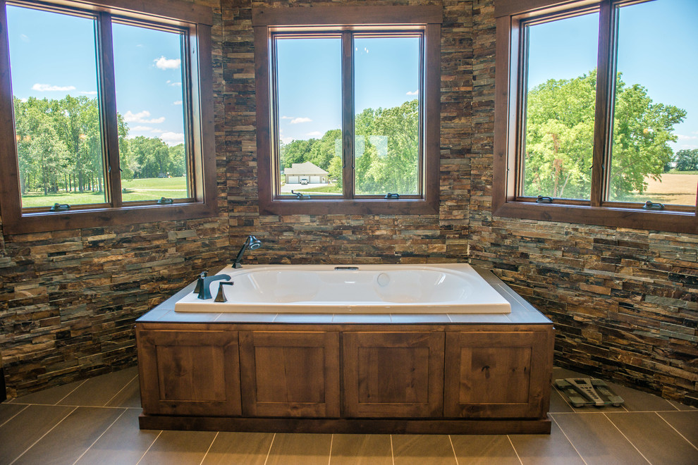 Freestanding bathtub - huge rustic master slate tile porcelain tile and brown floor freestanding bathtub idea with flat-panel cabinets, medium tone wood cabinets, a one-piece toilet, multicolored walls, an undermount sink and marble countertops